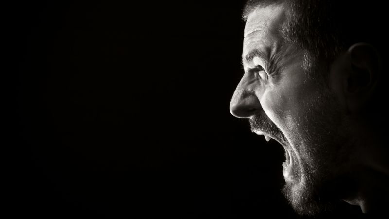 profile of man screaming in anger