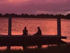 Four people against a purple sky in Sunset Cove Amphitheater, Boca Raton, Florida, USA